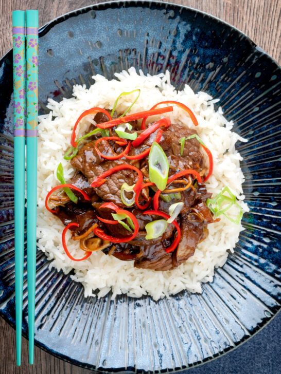 Overhead Chinese stir-fried beef in oyster sauce with fresh chilli and rice.