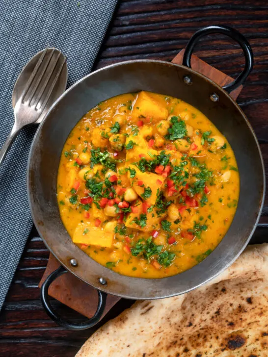 Overhead sweet potato and chickpea curry with coconut milk and fresh coriander.