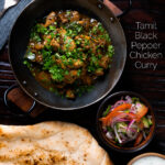 Overhead Tamil black pepper chicken curry, aka Chettinad chicken with naan and salad featuring a title overlay.