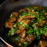Close-up Tamil black pepper chicken curry, aka Chettinad chicken.