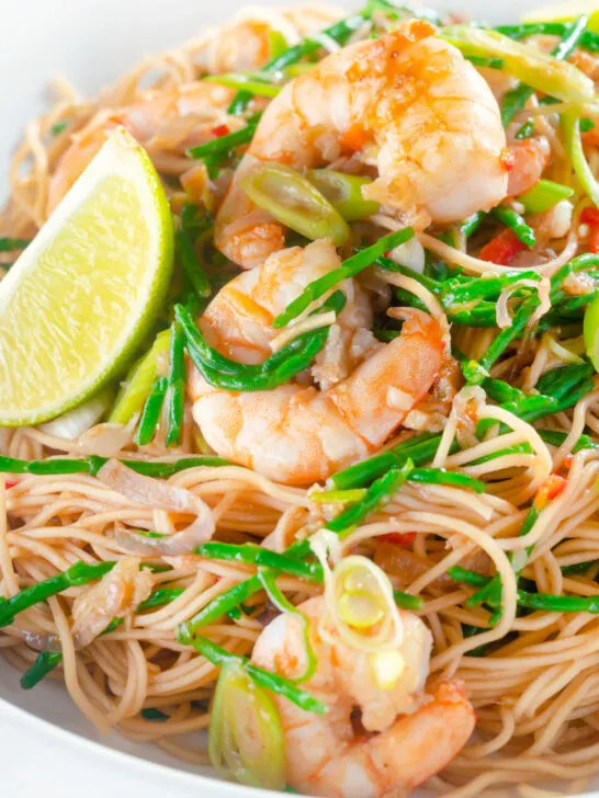 Close-up Thai influenced prawn stir fry with samphire and egg noodles.