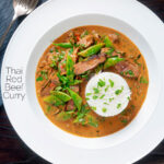Overhead Thai red beef curry with sugar snap peas and coconut milk sauce featuring a title overlay.