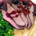 Overhead close-up Wild boar haunch steak with blackberry sauce, cabbage and mashed potato featuring a title overlay.