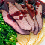 Overhead close-up Wild boar haunch steak with blackberry sauce, cabbage and mashed potato featuring a title overlay.