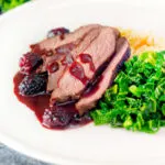 Wild boar haunch steak with blackberry sauce, cabbage and mashed potato..