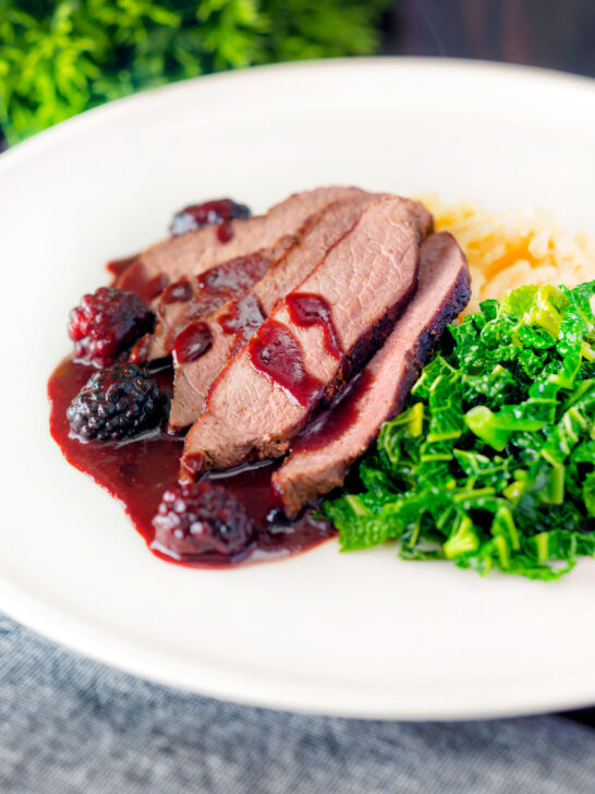 Wild boar haunch steak with blackberry sauce, cabbage and mashed potato..