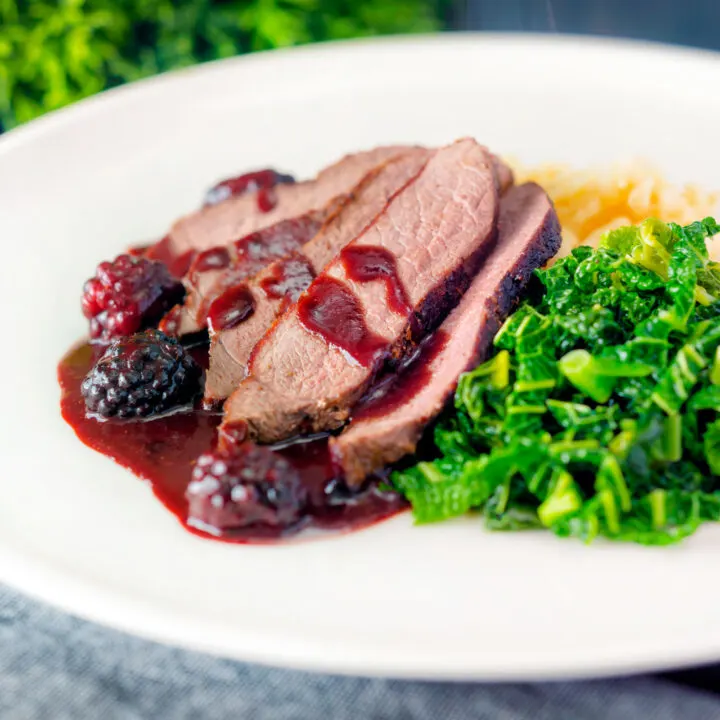 Wild boar haunch steak with a blackberry sauce, buttered cabbage and mashed potato.