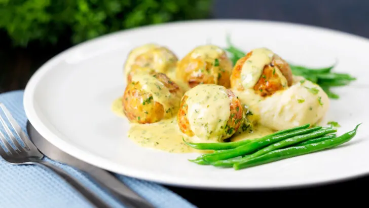 Chicken meatballs with creamy honey mustard sauce, green beans and mashed potato.