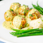 Chicken meatballs with honey, mustard sauce and mashed potato.