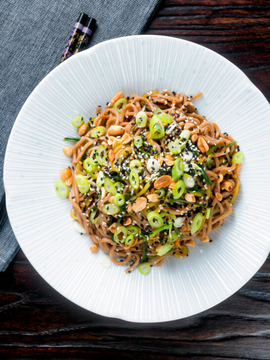 Overhead easy soba noodle salad with cucumber, toasted peanuts and sesame seeds.