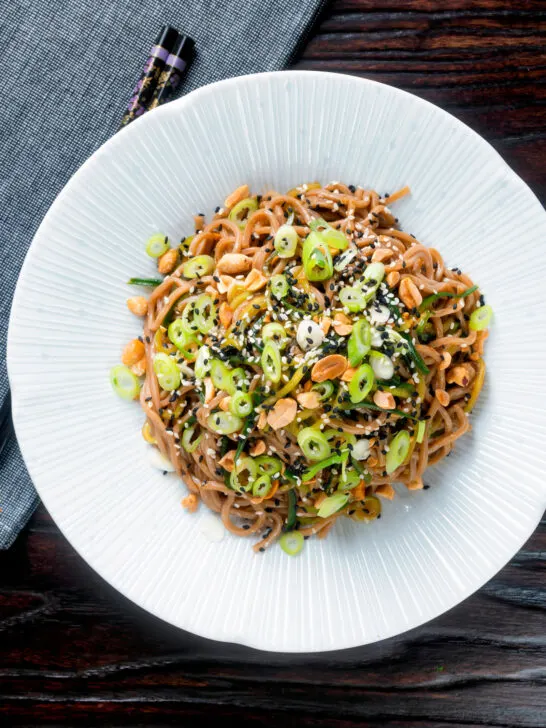 Overhead easy soba noodle salad with cucumber, toasted peanuts and sesame seeds.