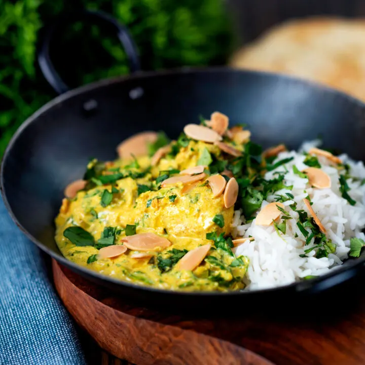 Creamy Indian chicken pasanda or passanda curry with rice and naan bread.