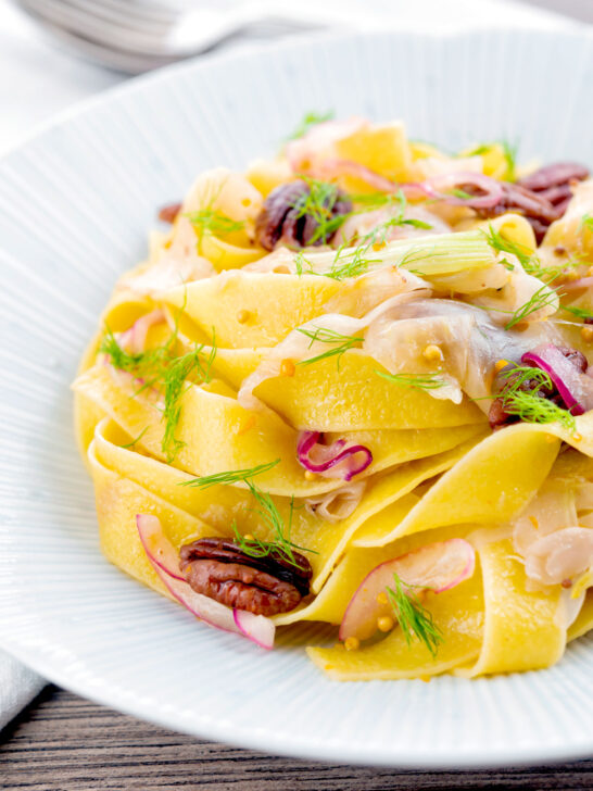 Fennel and orange pasta with red onions and pecan nuts.