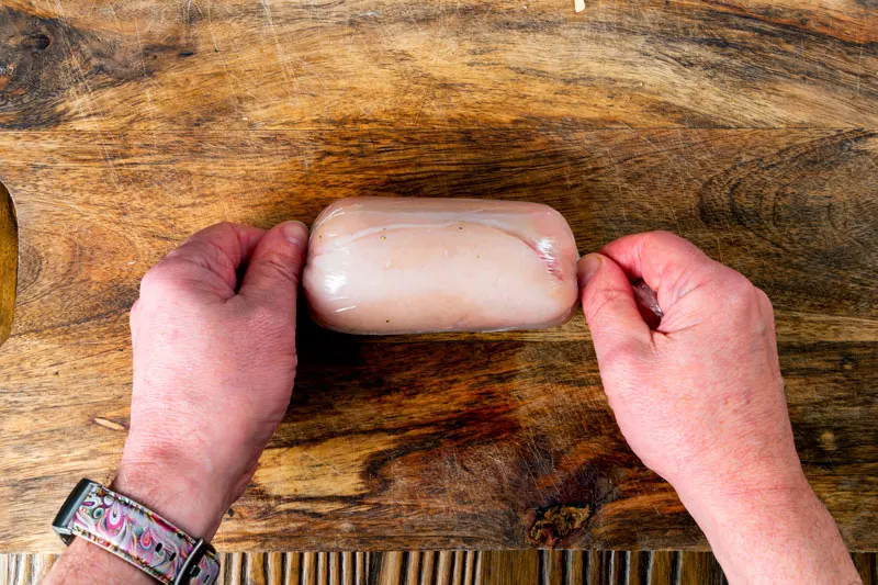 Rolling chicken breast to panne for cordon bleu.