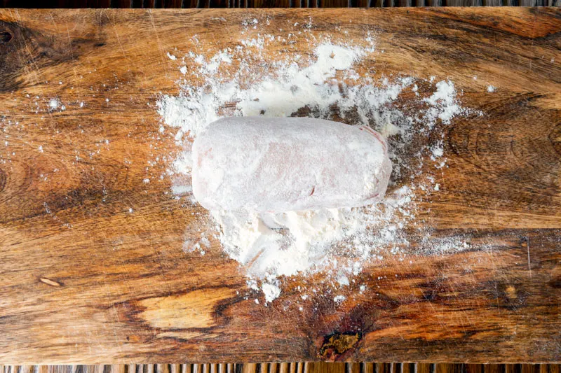 Floured chicken for cordon bleu dusted with flour.