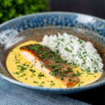 Indian inspired salmon curry with a yoghurt sauce and rice with fresh coriander.