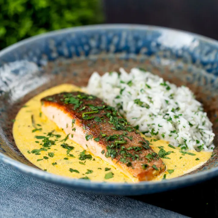 Indian inspired salmon curry with a yoghurt sauce and rice with fresh coriander.