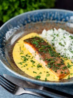 Indian salmon fillet curry with crispy skin in a yoghurt sauce served with rice.