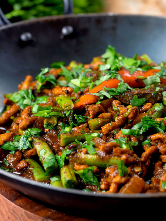 Close-up hot and sour pork mince curry with green beans.