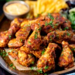 Peri peri chicken wings with fries, spicy mayonnaise and salad.