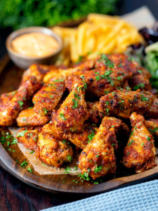 Peri peri chicken wings with fries, spicy mayonnaise and salad.