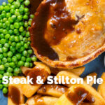 Overhead close-up steak and Stilton pie with chips, peas and gravy featuring a title overlay.