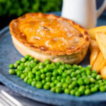 Beef and Stilton pie with chips, garden peas and gravy.