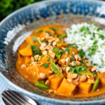 Vegan satay sweet potato curry with a coconut milk sauce featuring a title overlay.