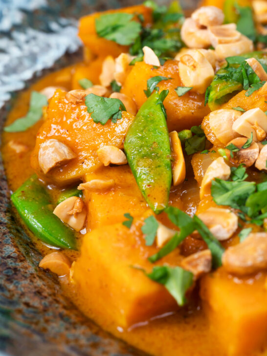 Close-up vegan satay sweet potato curry with a coconut milk sauce.