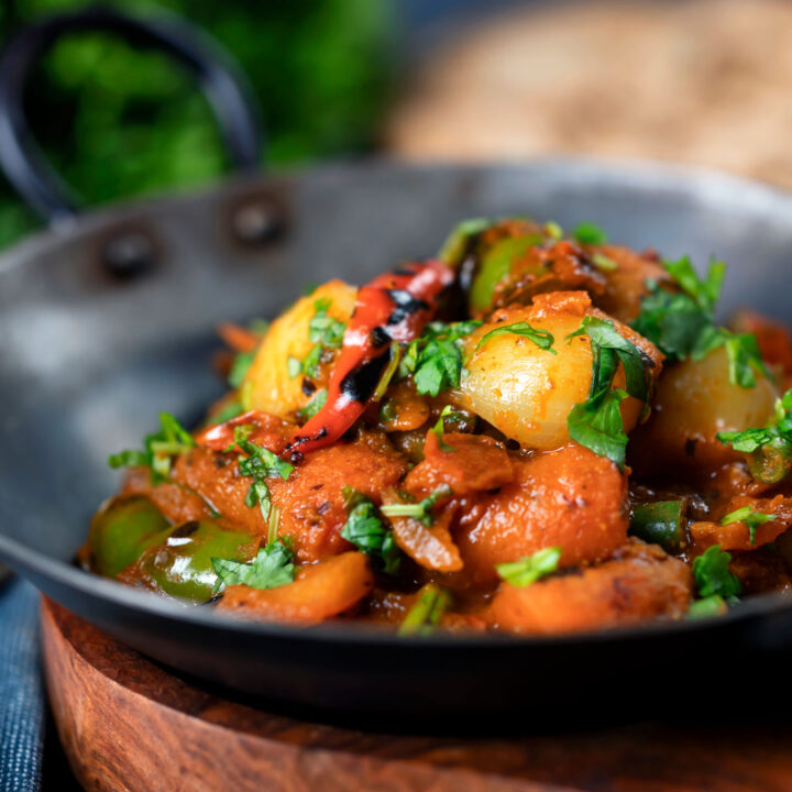 Indian restaurant style vegan vegetable bhuna serves in an iron pot.