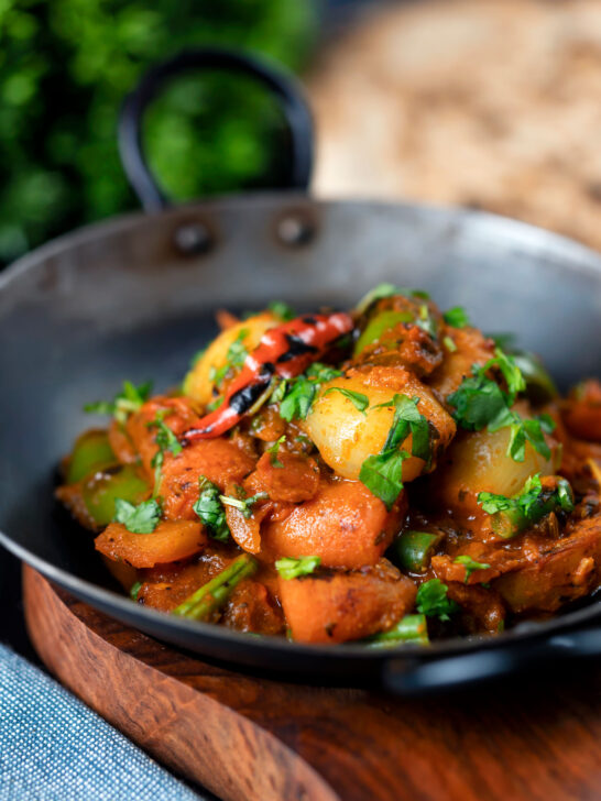 Vegan vegetable bhuna Indian curry served a naan bread.