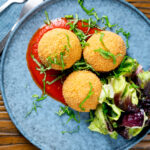 Overhead air fryer cooked arancini with an easy tomato sauce.