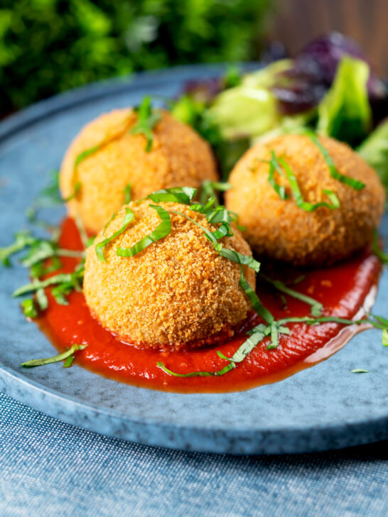 Air fryer cooked arancini with an easy tomato sauce and fresh basil..