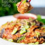 UK Chinese takeaway style chicken egg foo yung omelette being eaten with chopsticks featuring a title overlay.