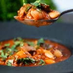 Fasolia, Lebanese-influenced lamb and butter bean stew one a spoon.