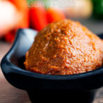 Homemade easy Red Thai curry paste presented in a bowl featuring a title overlay.