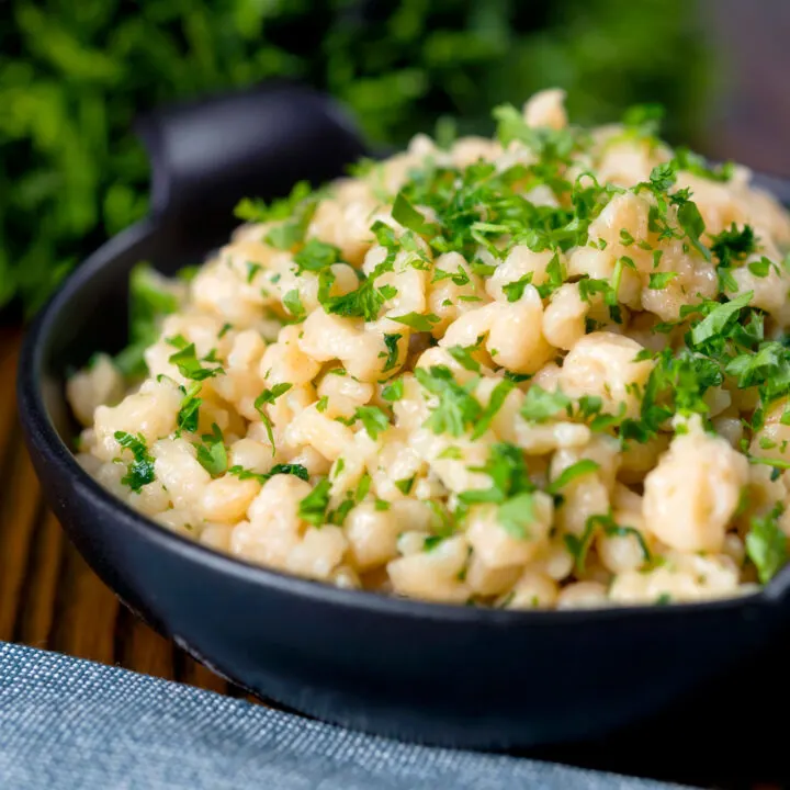 Hungarian nokedli dumplings or noodles served with fresh parsley.