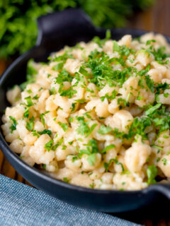 Homemade Hungarian nokedli dumplings with fresh parsley.