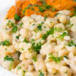 Homemade Hungarian nokedli dumplings served with pork paprikash.