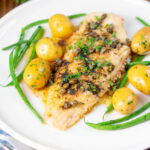 Whole pan-fried lemon sole meuniere with a caper and butter sauce.