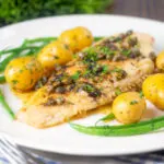 Whole pan-fried lemon sole meuniere served with new potatoes and green beans.
