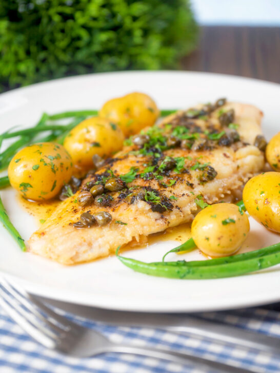 Whole pan-fried lemon sole meuniere served with new potatoes and green beans.