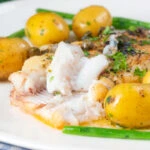 Whole pan-fried lemon sole meuniere showing the texture of the cooked flesh.