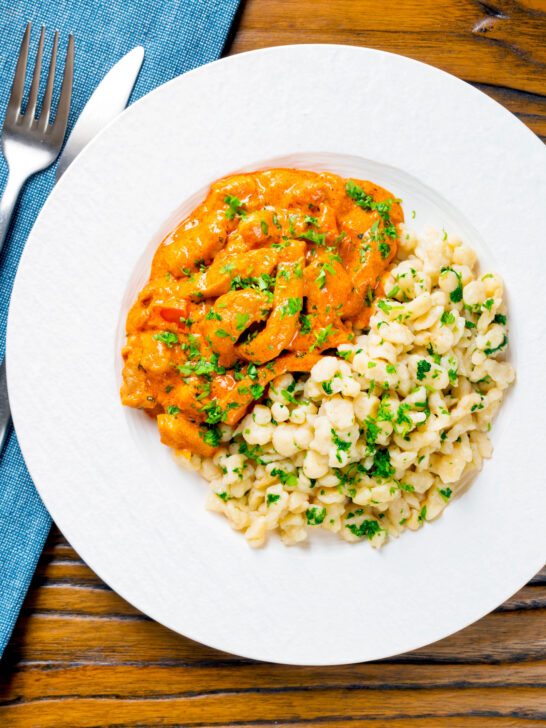 Overhead Hungarian pork paprikash served with homemade nokedli.