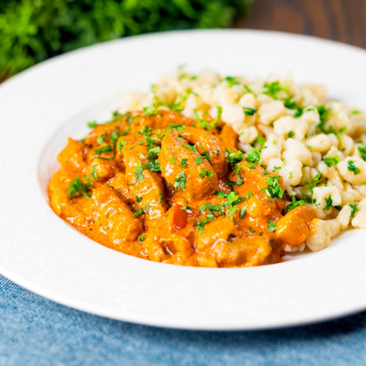 Hungarian pork paprikash in a paprika-rich sauce served with nokedli.