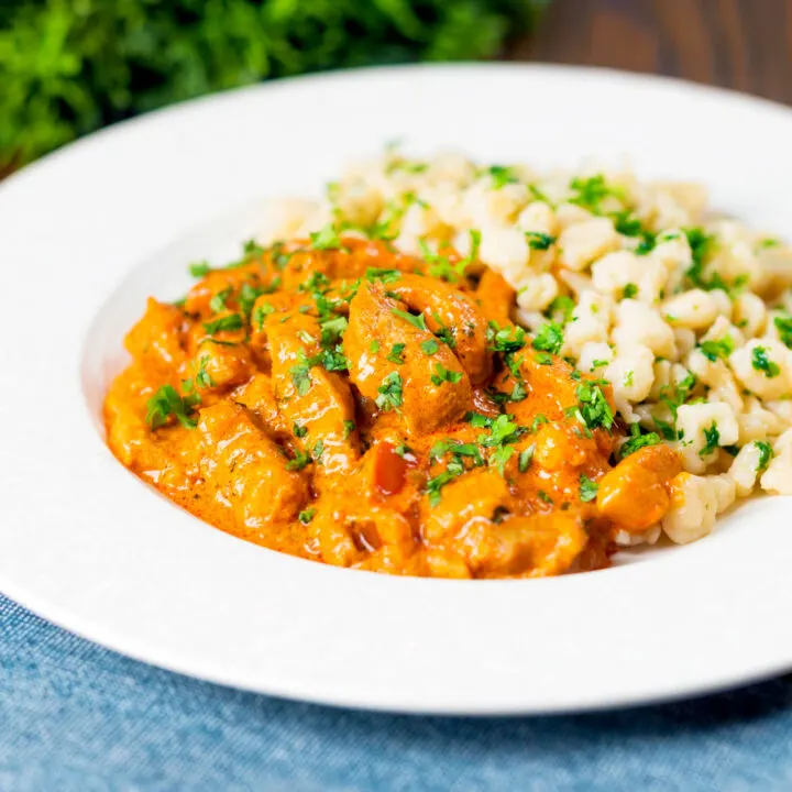 Hungarian pork paprikash in a paprika-rich sauce served with nokedli.