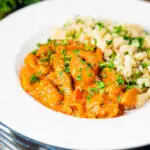 Hungarian pork paprikash served with homemade nokedli featuring a title overlay.