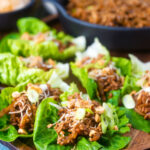 Chinese takeaway minced pork yuk sung with lettuce cups fried noodles and peanuts.