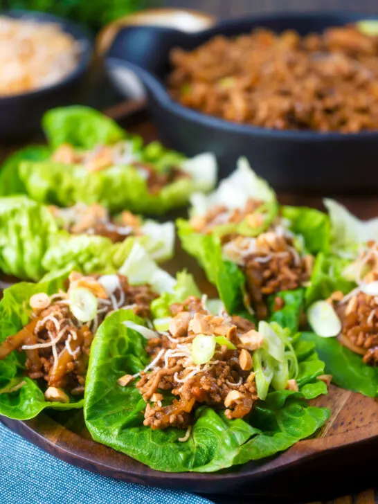 Chinese takeaway minced pork yuk sung with lettuce cups fried noodles and peanuts.