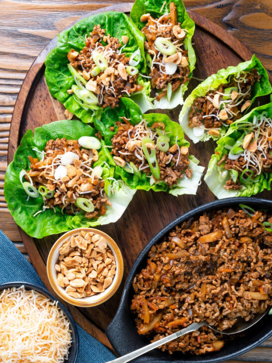 Chinese takeaway minced pork yuk sung stuffed in lettuce cups with fried noodles and peanuts.